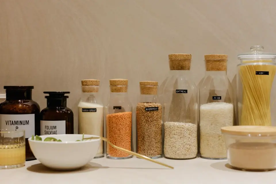 A supplement bottle and measuring scoop sitting on a kitchen counter